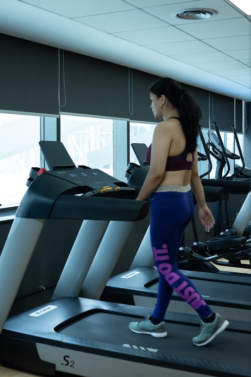 Walking on a treadmill at the gym.
